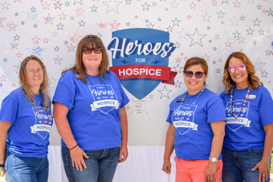 Choice bank posing in front of Heroes for Hospice banner