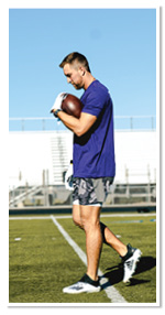 Adam Thielen holding a football.