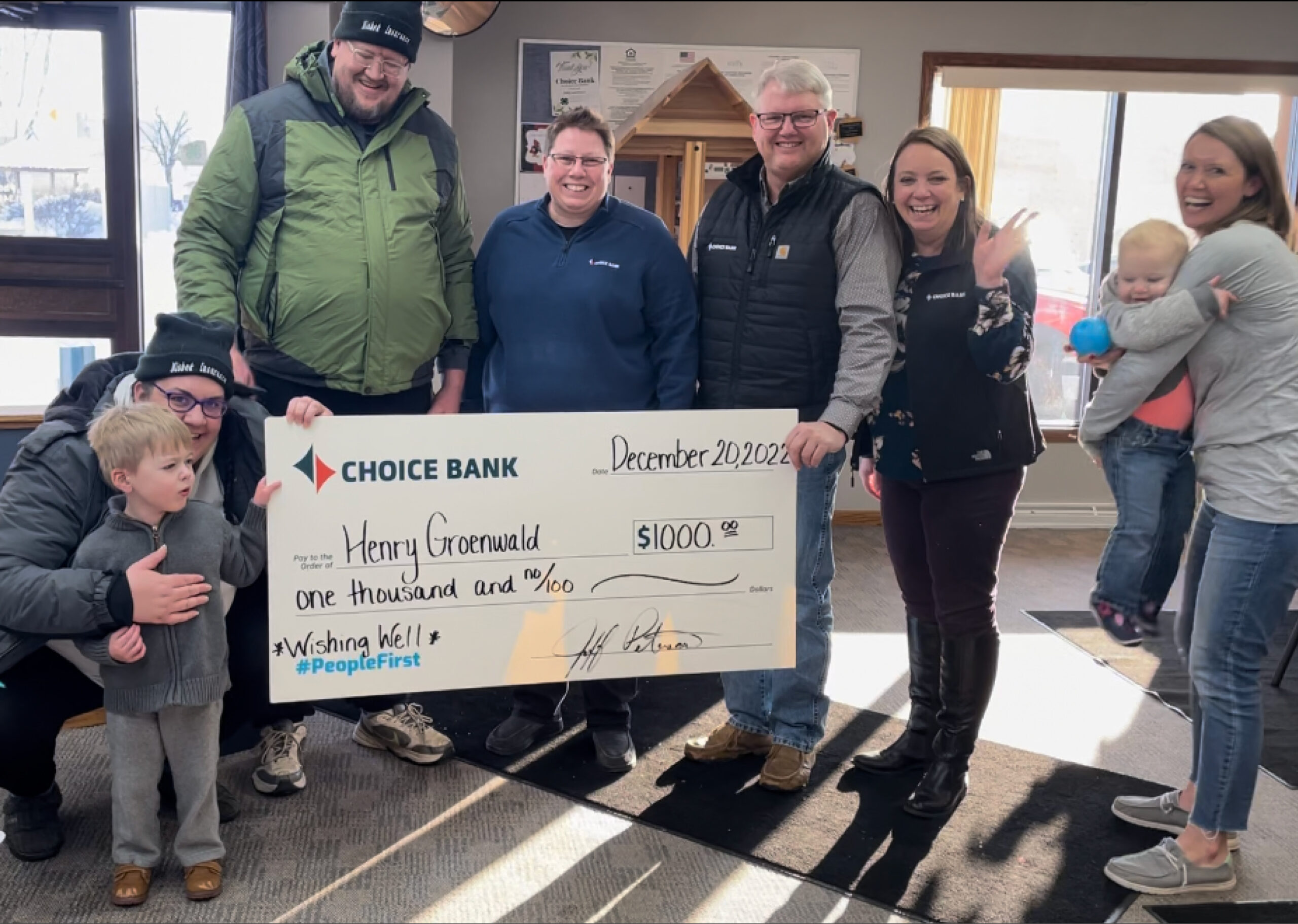 Family Stands with giant check