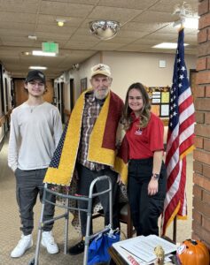 man with quilt and family