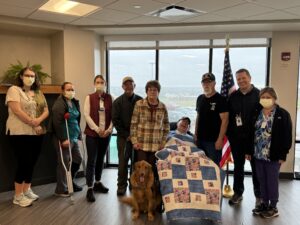 man with quilt and family