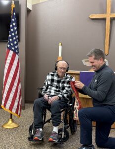 man receives pin for military service
