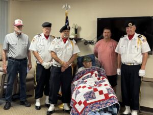 man poses with military veterans