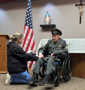 man receives pin for military service